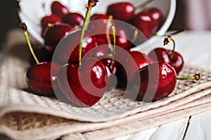 Delicious ripe cherries scattered on the kitchen towel