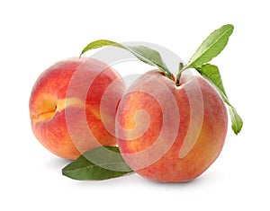 Delicious ripe juicy peaches with leaves isolated