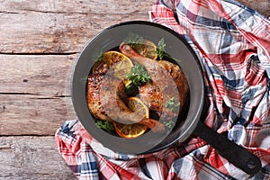 Delicious roasted duck leg with oranges close-up. top view