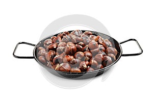 Delicious roasted edible chestnuts in wok frying pan isolated on white