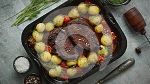 Delicious roasted goose breast served with vegetables, potatoes. Placed in metal baking dish