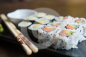 delicious rolls of rice with fish or makis, with their oriental chopsticks photo