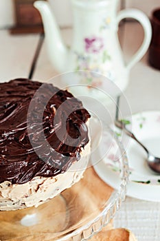 Delicious round cake with white buttercream topped with chocolate frosting, coating. Holiday and festive food concept