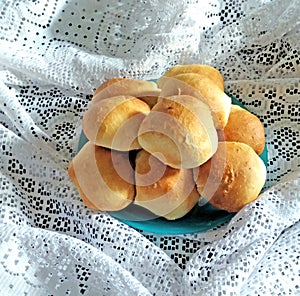 Delicious round small buns on a blue plate