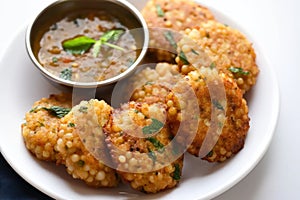 Delicious sabudana wada sago fritters with coconut chutney for a tasty and crunchy snack, gudi padwa sweets and cuisine photo