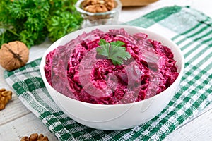 Delicious salad with boiled beets, herring, nuts, onions