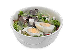 Delicious salad with boiled egg, feta cheese and vegetables in bowl isolated on white