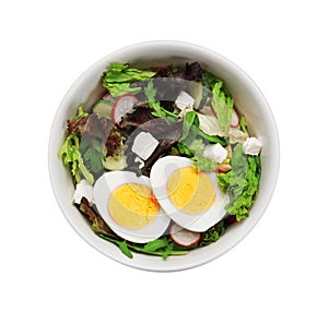 Delicious salad with boiled egg, feta cheese and vegetables in bowl isolated on white, top view
