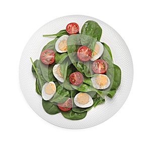 Delicious salad with boiled eggs, tomatoes and spinach isolated on white, top view