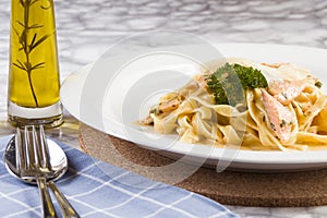 Delicious salmon pasta dish, tagliatelle noodles with Parmesan and parsley