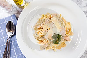 Delicious salmon pasta dish, tagliatelle noodles with Parmesan and parsley