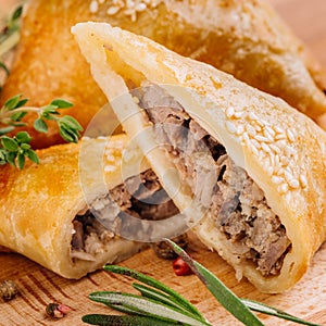 Delicious samosa pies with meat on plate. Menu, restaurant, recipe concept. Served in traditional oriental restaurant.