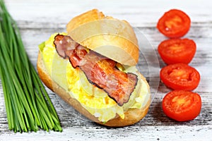 Delicious sandwich with bacon, scrambled egg and lettuce