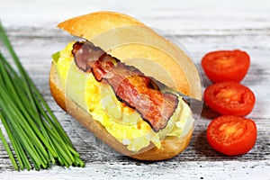 Delicious sandwich with bacon, scrambled egg and lettuce