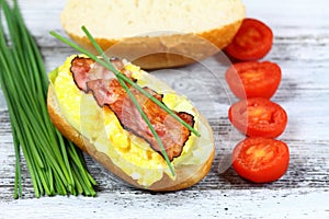 Delicious sandwich with bacon, scrambled egg and lettuce