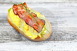 Delicious sandwich with bacon, scrambled egg and lettuce