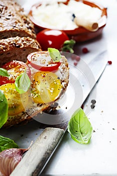 Delicious sandwich with slices of tomatoes and basil