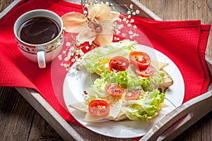 Delicious sandwich with tomatoes, cheese and lettuce.