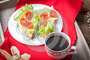 Delicious sandwich with tomatoes, cheese and lettuce.