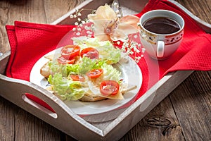 Delicious sandwich with tomatoes, cheese and lettuce.