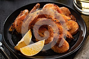 Delicious scene with fried shrimps on black plate