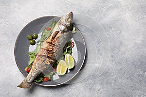 Delicious sea bass fish and ingredients on light grey table, top view. Space for text