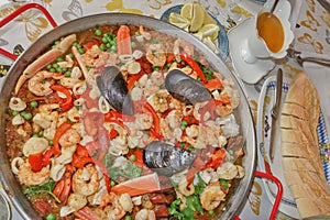 Delicious seafood paella at convivial table.