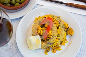 Delicious seafood paella - traditional Valencian rice dish with shrimps, calamari and shellfish