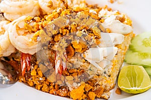 Delicious seafood thai fried rice (crab meat, shrimp, crab roe and squid) closeup