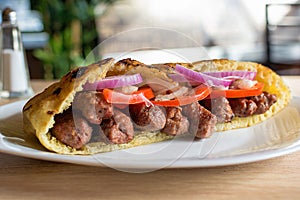 Delicious Serbian beef kebab sandwich in pita bread with fresh salad ingredients