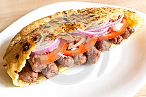 Delicious Serbian beef kebab sandwich in pita bread with fresh salad ingredients