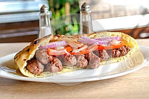 Delicious Serbian beef kebab sandwich in pita bread with fresh salad ingredients