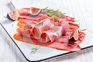 Delicious Serrano ham with fresh figs and rosemary