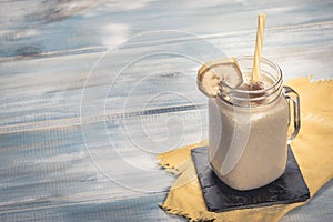 Delicious shake in cup with slices of fruit