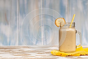 Delicious shake in cup with slices of fruit