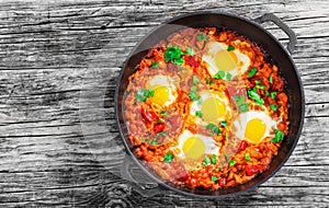 Delicious shakshuka - fried eggs, onion,bell peppers,tomatoes an