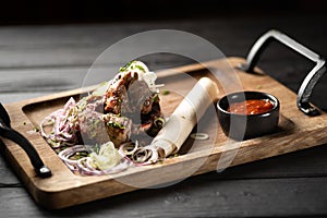 Delicious shish kebabs with lavash and sauce on wooden board