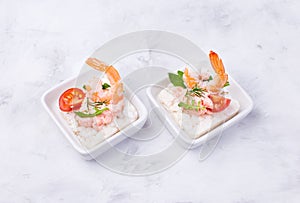 Delicious shrimp canapes with tomato and arugula on a light background. Festive appetizer with seafood