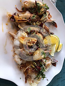 Delicious shrimp with seasoning, lime, cilantra photo