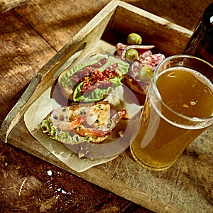 Delicious shrimp and veggetable tapas snack with beer photo