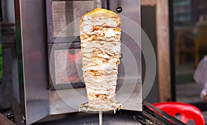 Delicious slabs of skewered fast food shawerma chicken and lamb meat on a spit.