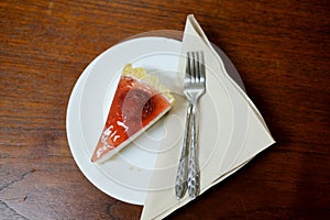 Delicious slice of cheesecake with strawberry sauce