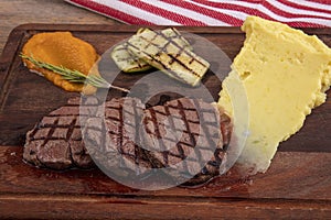 Delicious sliced beef tenderloin on table, closeup. Sirloin steak