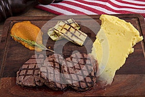 Delicious sliced beef tenderloin on table, closeup. Sirloin steak