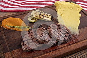 Delicious sliced beef tenderloin on table, closeup. Sirloin steak