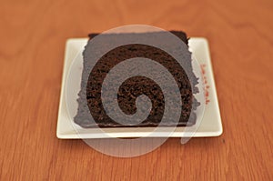 Delicious sliced cake on wood table