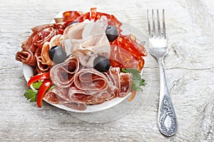 Delicious sliced ham. Platter of assorted cured meats and