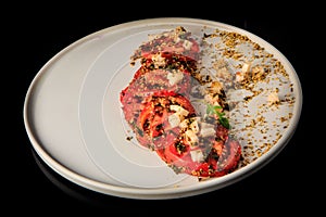 Delicious sliced tomato exquisite decorated with assorted herbs