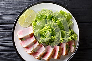 Delicious sliced tuna steak fried in breading served with leaf s