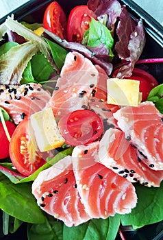 Delicious slices of scalded salmon with salad